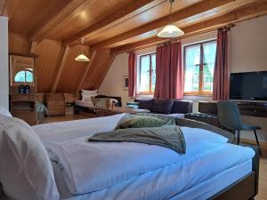a bedroom with a large bed and a living room at Hotel Bezold in Rothenburg ob der Tauber