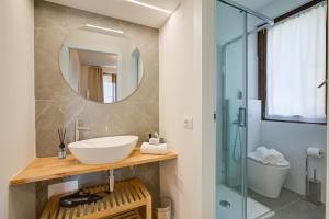 a bathroom with a sink and a mirror at Il Vecchio Faggio: Lake Maggiore view Terrace - Happy Rentals in Gignese