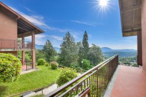 a balcony with a view of the mountains at Il Vecchio Faggio: Lake Maggiore view Terrace - Happy Rentals in Gignese +27 photos