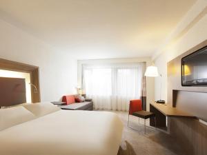 a hotel room with a bed and a television at Novotel Metz Centre in Metz +79 photos