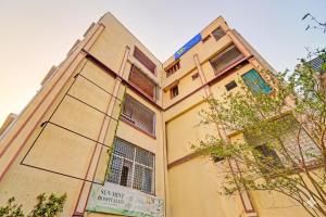 a tall building with windows on the side of it at FabHotel Sun Mint - Jubilee Hills in Hyderabad