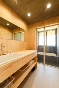 a bathroom with a tub and a large mirror at DEAR MOM - Hotel & Cafe in Onjuku +36 photos