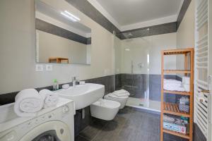 a white bathroom with a sink and a toilet at Studio Azur with Sea View Terrace - Happy Rentals in Cap d'Ail