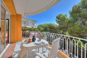a patio with a table and chairs on a balcony at Studio Azur with Sea View Terrace - Happy Rentals in Cap d'Ail +18 photos