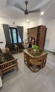 a living room with a couch and a table at Casa Luminaria in Alleppey