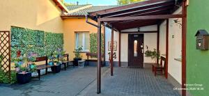 an entrance to a house with awning and plants at K14 Rooms Lublin in Lublin