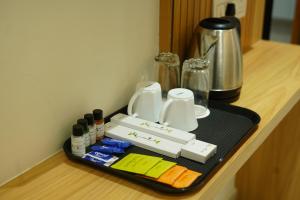 a tray with various items on top of a counter at Golden Tulip Peddapally in Peddapalli