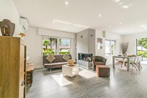 a living room with a couch and a table at La Rotonda Villa with Pool and Jacuzzi in Maroggia