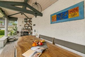 a wooden table in a room with a book on it at La Rotonda Villa with Pool and Jacuzzi in Maroggia +27 photos
