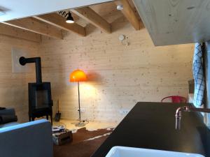 a living room with a table and a lamp at Ferienwohnungen beim Weilerbauer in Gerstetten