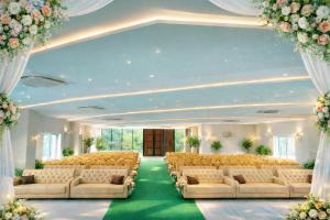 a large room with a row of couches and flowers at Golden Tulip Peddapally in Peddapalli