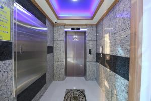 a elevator in a building with a purple ceiling at Daecheon Sea Joa Pension in Boryeong