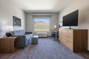 a hotel room with a couch and a television at Home2 Suites By Hilton Carson City in Carson City