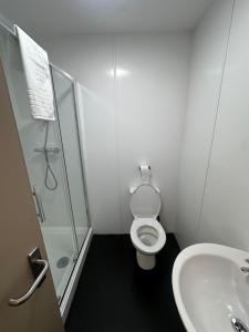 a bathroom with a shower and a toilet and a sink at The Cotteridge Inn in Birmingham +14 photos