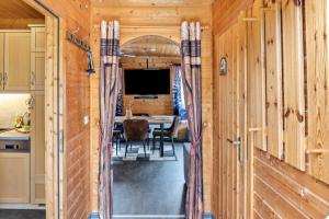 a kitchen and dining room with wooden walls and a dining table at Ferienhaus Obert - Drognitz in Drognitz