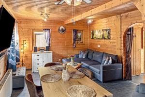 a living room with a couch and a table at Ferienhaus Obert - Drognitz in Drognitz
