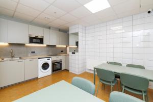 a kitchen with a table and chairs in a room at Air Kaunas apartment in Karmėlava +10 photos