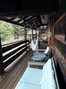 a room with two beds and a hammock on a boat at Hubertówka Dom in Ujanowice +6 photos
