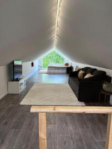 a living room with a couch and a table at Halsmo 6 in Kil