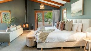 a bedroom with a large bed and a fireplace at Buffalo Bliss in Porepunkah