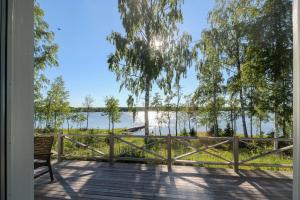a porch with a bench and a view of the water at Villa Björkholmen in Svartön