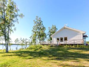 a white cottage on the shore of a lake at Villa Björkholmen in Svartön