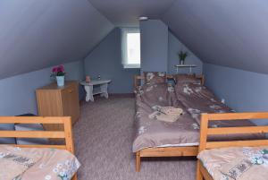 a bedroom with two beds in a attic at Singh Kuckó Bogács in Bogács
