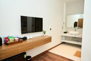 a bathroom with a sink and a large television on the wall at ARIA Hotel in Ninh Binh +49 photos