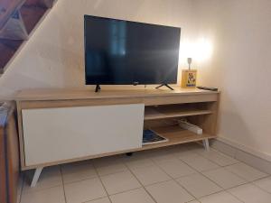 a flat screen tv sitting on top of a entertainment center at Maisonnette de caractère au calme in Fayence