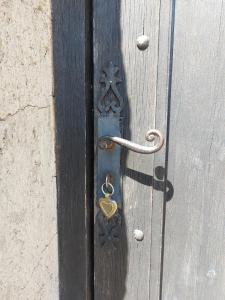 a wooden door with a metal door knocker on it at Maisonnette de caractère au calme in Fayence