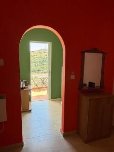 an archway in a room with a door leading to a kitchen at Art & Motion Union - Guest Room 3 in Apoíkia