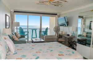 a bedroom with a bed and a view of the ocean at Beachfront 8th floor Studio - Stunning View in Galveston