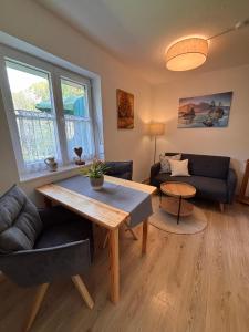 a living room with a table and a couch at Haus Auerhahn Ferienwohnungen in Ramsau