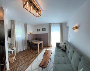 a living room with a couch and a table at Haus Auerhahn Ferienwohnungen in Ramsau