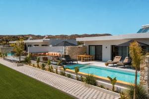 an image of a villa with a swimming pool at Celeste Luxury Villas in Lartos