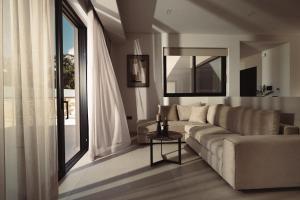 a living room with a couch and a large window at Orien, Seaside Luxury Villa in Argassi