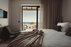 a bed with a teddy bear on it in a hotel room at Orien, Seaside Luxury Villa in Argassi +39 photos