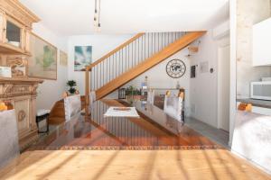 a staircase in a living room with wooden floors at Agriturismo da Natalino in Ceggia