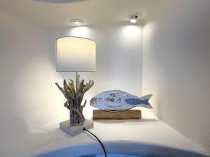 a lamp on a table with a fish on it at Villa Soprana by Agenzia SolturElba in Capoliveri +38 photos