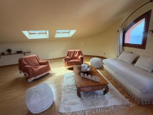 a living room with a couch and a table and chairs at Villa Soprana by Agenzia SolturElba in Capoliveri
