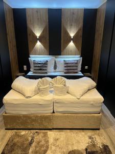a large bed with white sheets and pillows at Apartmenthaus Zeuthen 1 in Zeuthen