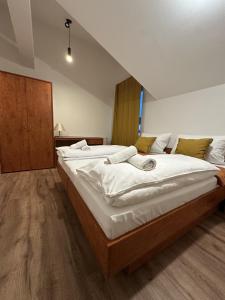 a bedroom with two large beds with white sheets at Apartmenthaus Zeuthen 1 in Zeuthen +16 photos