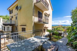 an apartment building with balconies and a balcony at Rooms Vera in Porat