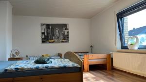 a bedroom with a bed and a window at Fewo Carpe Diem in Scheuerfeld