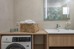 a bathroom with a sink and a washing machine at Desamani 975 in Kostrena +46 photos