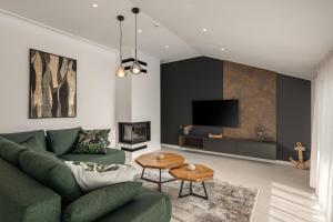 a living room with a green couch and a tv at Desamani 975 in Kostrena