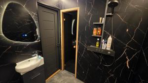 a bathroom with a sink and a toilet and a mirror at LuigeLaguun in Triigi