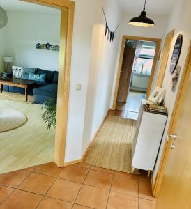 a hallway with a living room with a phone in it at Ferienwohnung DE VRIESenkoje in Südbrookmerland