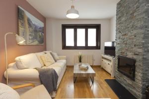 a living room with a couch and a fireplace at Casa MiMar by BeValle in Panticosa