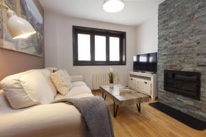 a living room with a couch and a fireplace at Casa MiMar by BeValle in Panticosa +23 photos